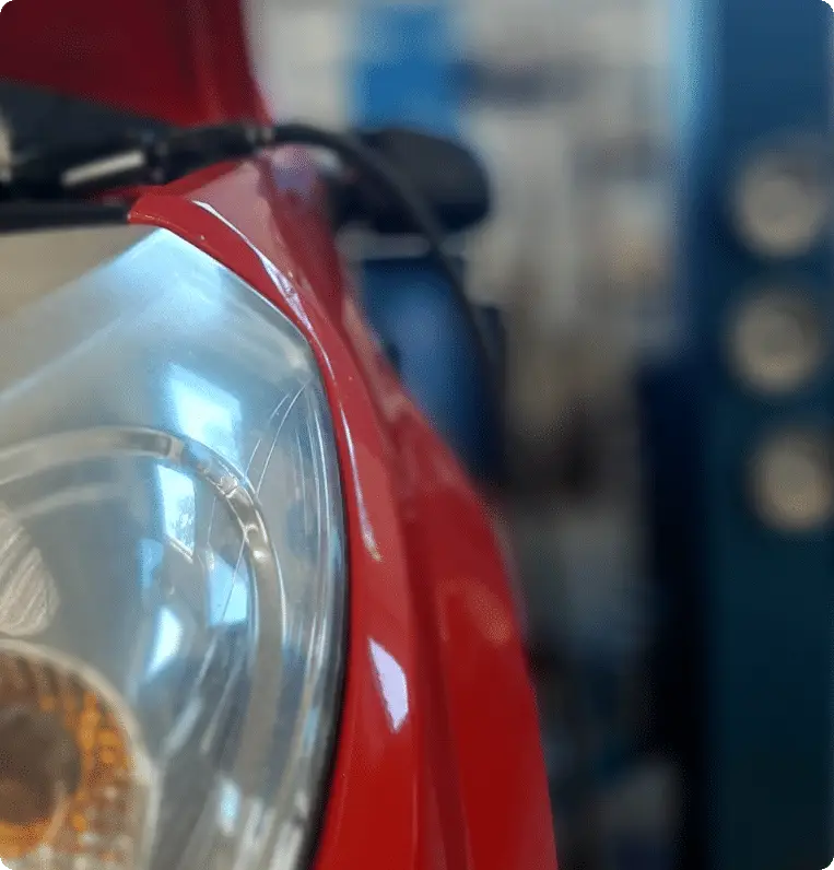 Phare avant d’un véhicule en intervention dans l’atelier du garage Ottélec à Strasbourg